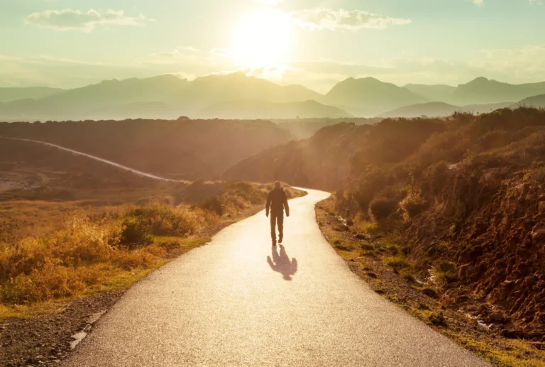 Man walking on mountain road to illustrate a personalized customer journey